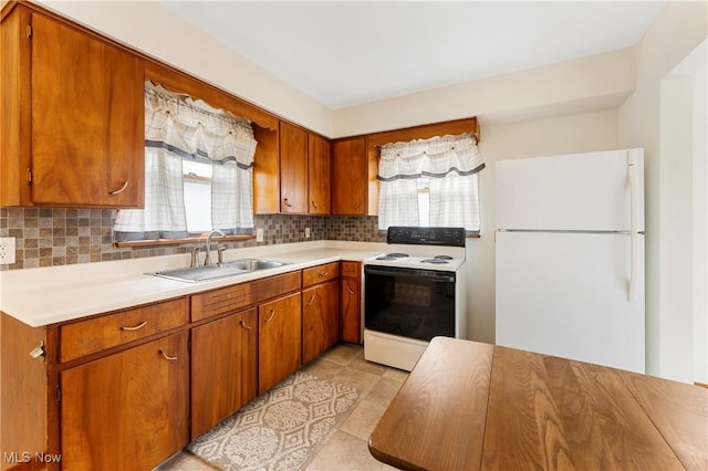 449 W Long Lake Blvd, Akron, OH 44319 - kitchen featuring electric range, a sink, light countertops, freestanding refrigerator, and decorative backsplash