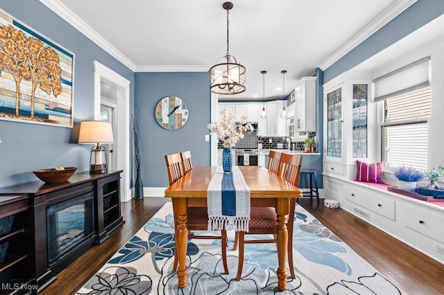 dining area featuring crown molding, dark wood-style flooring, and visible vents