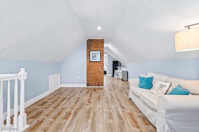 bonus room featuring baseboards, wood finished floors, and vaulted ceiling