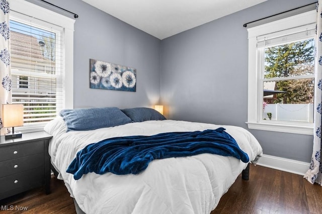 bedroom featuring baseboards and dark wood-style floors