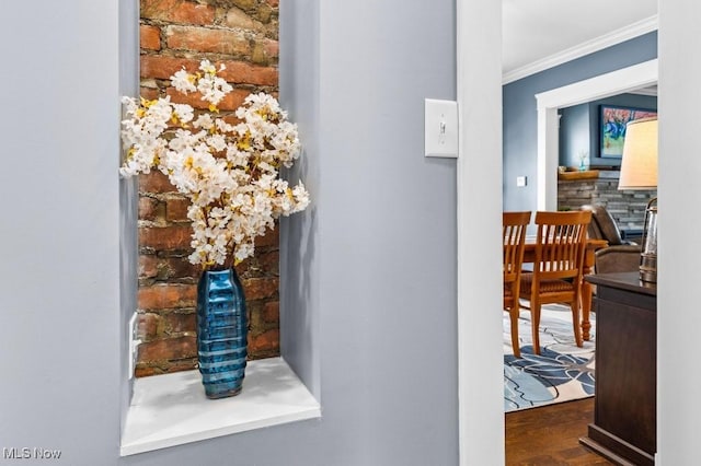 details featuring ornamental molding and wood finished floors