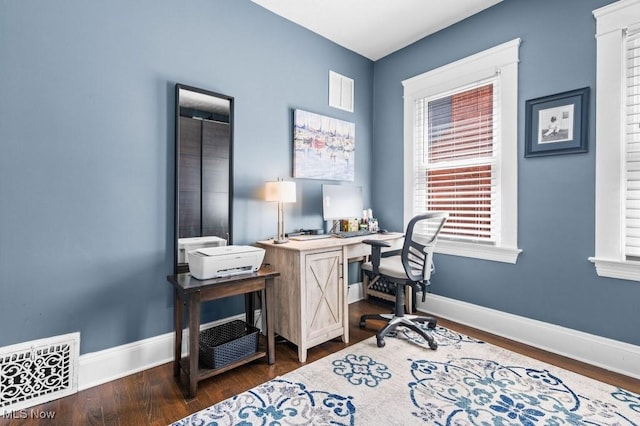 office space featuring baseboards, dark wood-style flooring, and visible vents