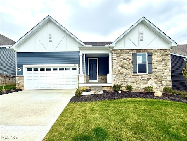 view of front of house featuring concrete driveway, a front yard, an attached garage, and stone siding