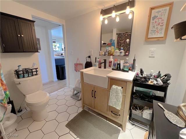 bathroom with vanity, tile patterned flooring, and toilet