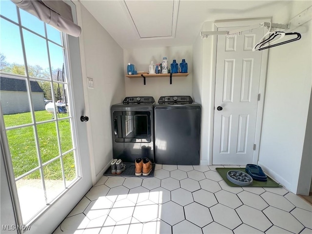 laundry area with a healthy amount of sunlight, baseboards, laundry area, and washing machine and dryer