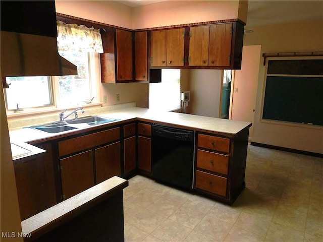 kitchen featuring light countertops, a peninsula, a sink, and dishwasher