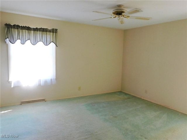 empty room with carpet floors, ceiling fan, and visible vents