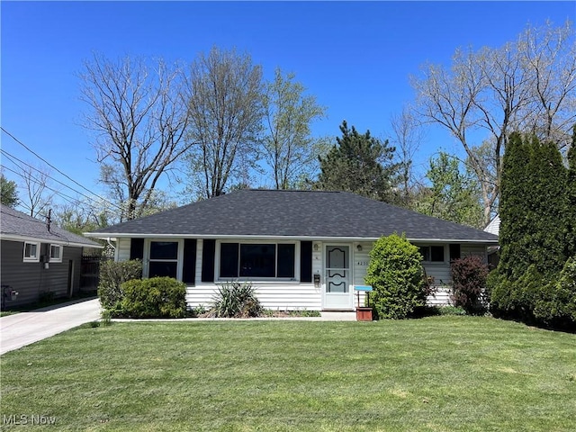 ranch-style house with a shingled roof and a front lawn