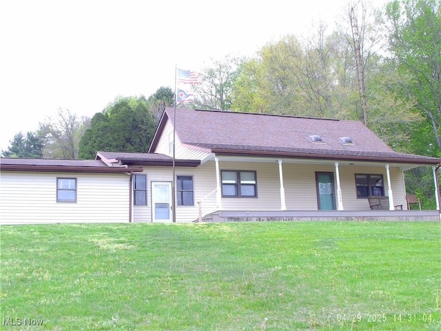 view of front of house with covered porch and a front yard