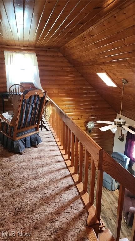 staircase with ceiling fan, lofted ceiling, and wooden ceiling