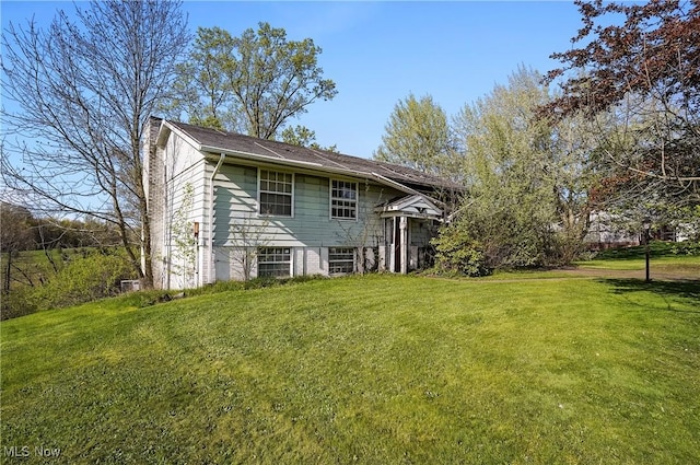 rear view of house with a lawn and a chimney