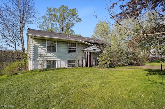 back of property featuring a yard