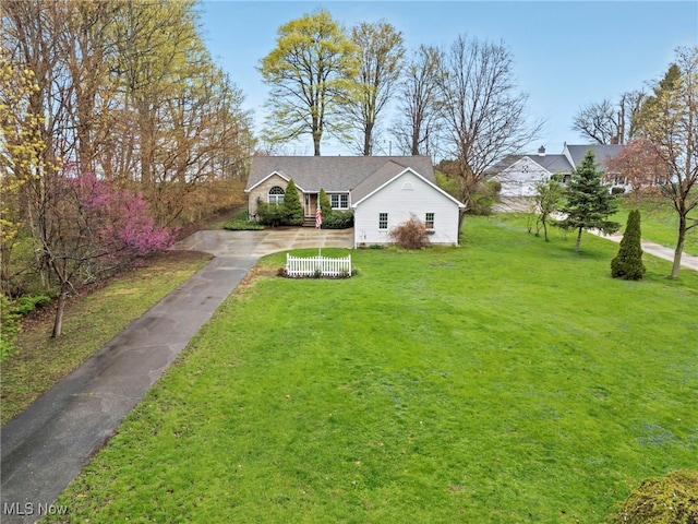 bungalow with driveway and a front lawn