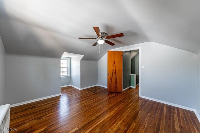 additional living space featuring baseboards, a ceiling fan, lofted ceiling, and hardwood / wood-style floors