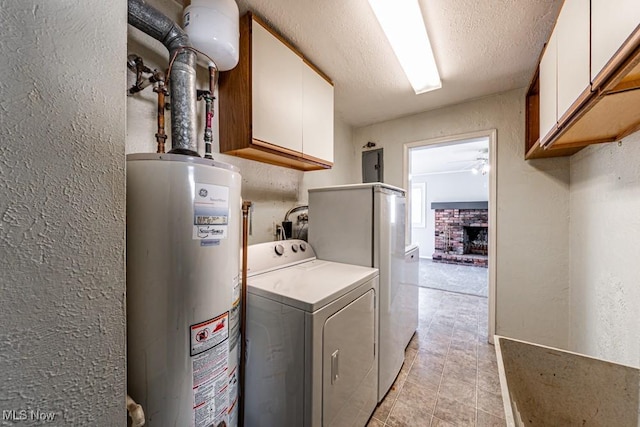 washroom featuring cabinet space, a textured wall, water heater, and electric panel