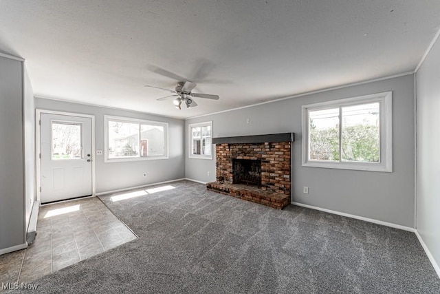 unfurnished living room featuring baseboards, ceiling fan, carpet, and a brick fireplace