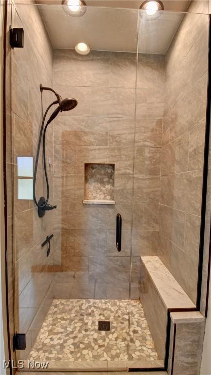 bathroom featuring a stall shower and recessed lighting