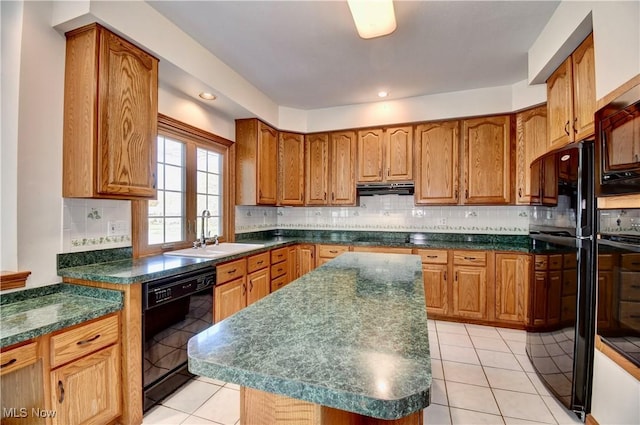 kitchen with brown cabinets, dark countertops, a sink, and black appliances