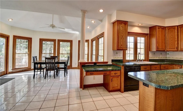 kitchen with a sink, decorative columns, black dishwasher, and brown cabinets