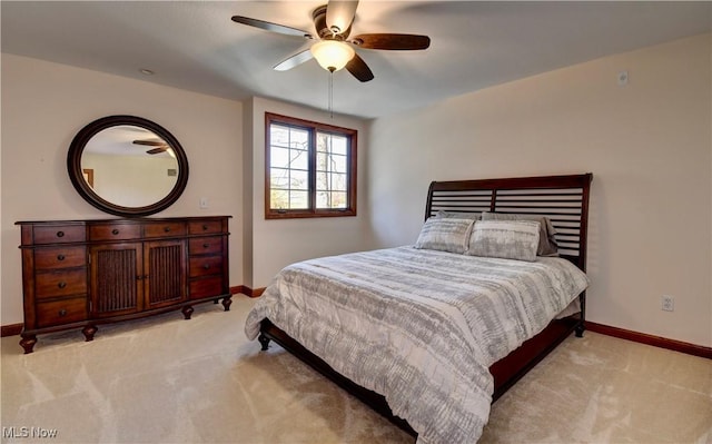 bedroom featuring a ceiling fan, baseboards, and light carpet