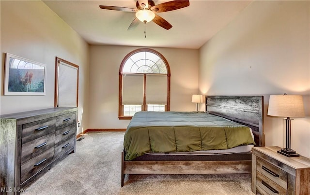 bedroom featuring baseboards, a ceiling fan, and light carpet