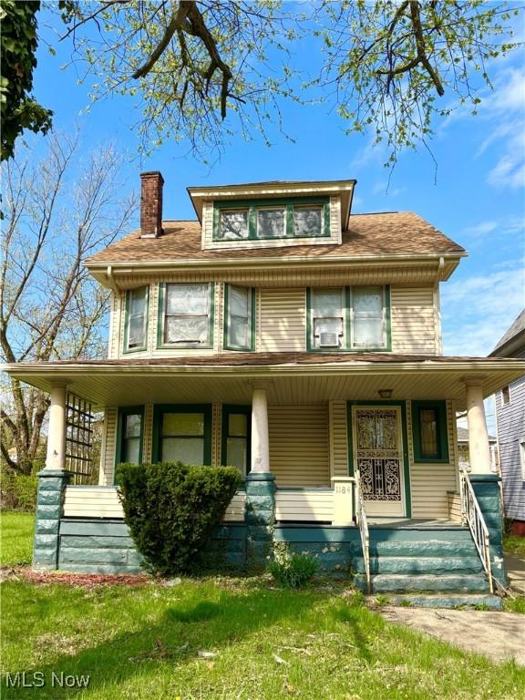 view of front of home with covered porch and a chimney