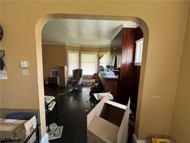 home office with arched walkways, wood finished floors, and ornamental molding