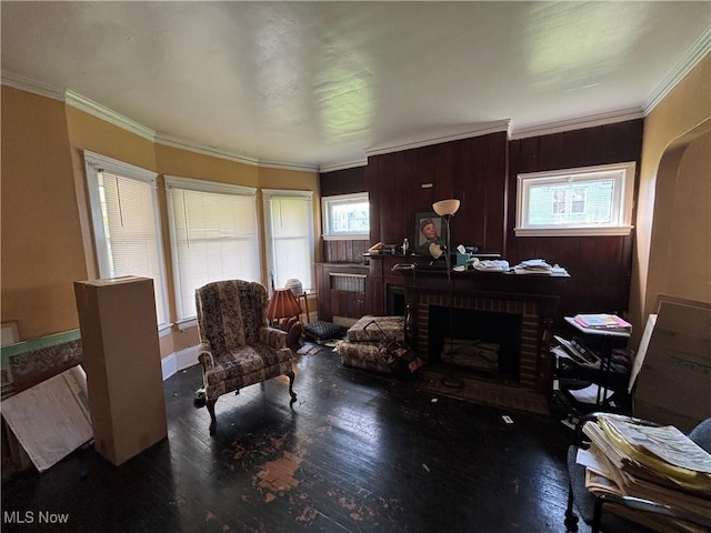 living area with a healthy amount of sunlight, a fireplace, and wood finished floors