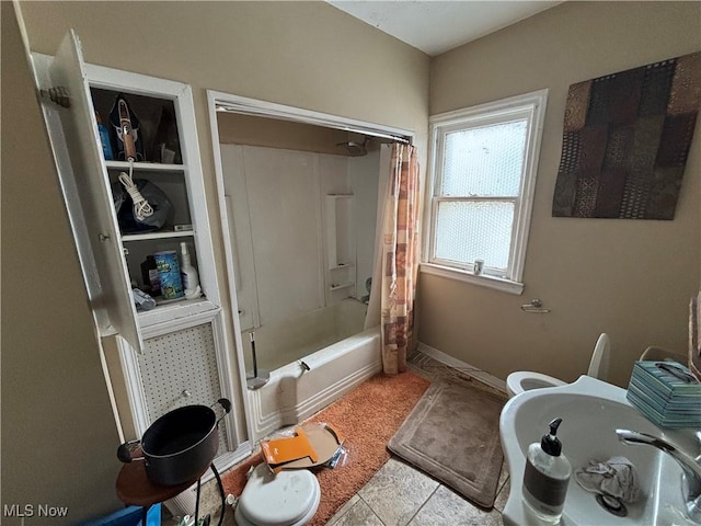 full bathroom with shower / bath combo with shower curtain and toilet