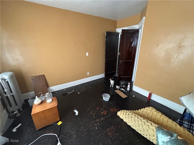 bedroom with radiator heating unit and baseboards