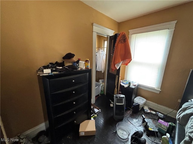bedroom with baseboards and multiple windows