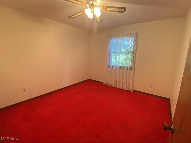 8995 Sarbaugh Rd, Norwich, OH 43767 - spare room featuring ceiling fan, baseboards, and dark colored carpet
