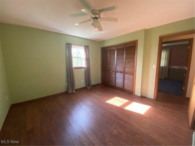 8995 Sarbaugh Rd, Norwich, OH 43767 - unfurnished bedroom with a ceiling fan, baseboards, wood finished floors, and a closet