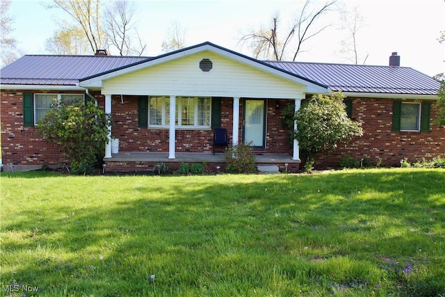 8995 Sarbaugh Rd, Norwich, OH 43767 - single story home featuring a chimney, a porch, a front lawn, and brick siding