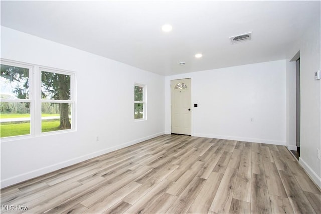 empty room with recessed lighting, baseboards, visible vents, and light wood-type flooring