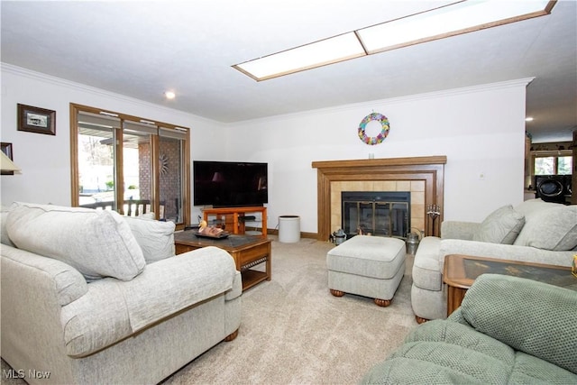 living area featuring crown molding, a tiled fireplace, light carpet, and washer / dryer
