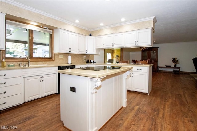 kitchen featuring a center island, light countertops, dark wood-style floors, black electric stovetop, and white cabinetry