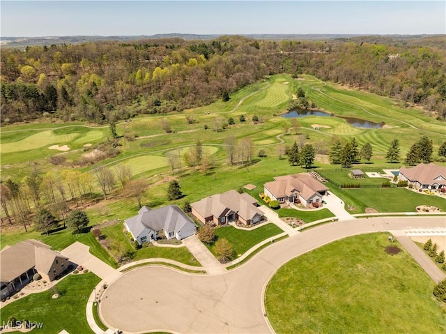 birds eye view of property with a water view, golf course view, a residential view, and a forest view