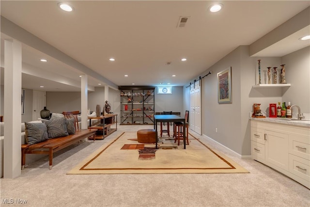 game room with recessed lighting, a sink, light carpet, and a barn door