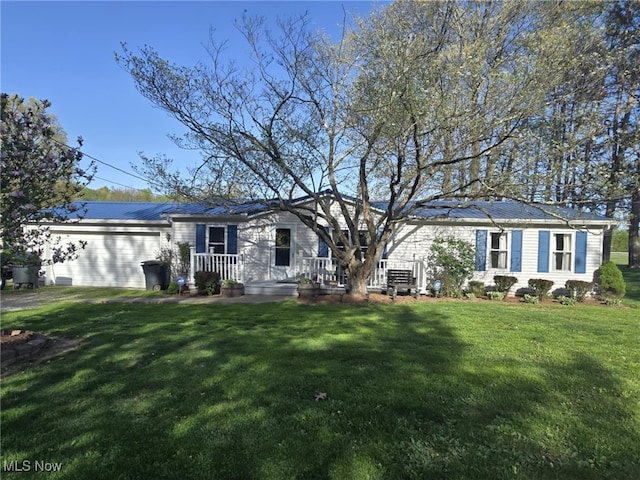 ranch-style home with an attached garage, metal roof, and a front yard