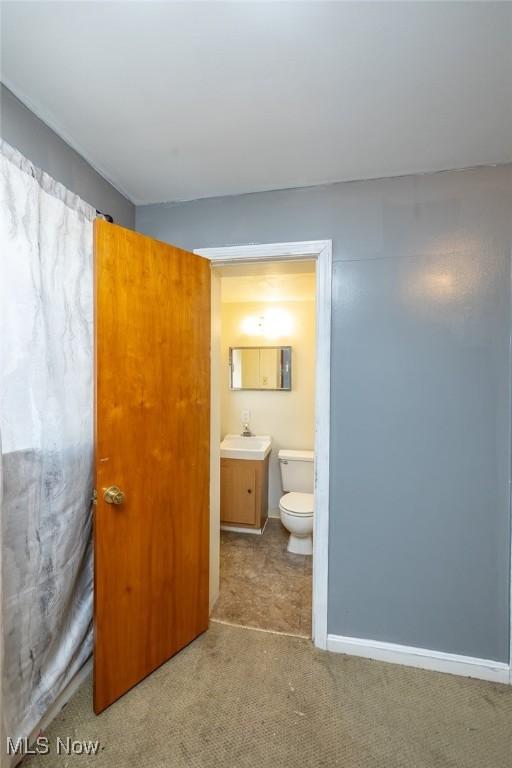 bathroom featuring toilet and vanity