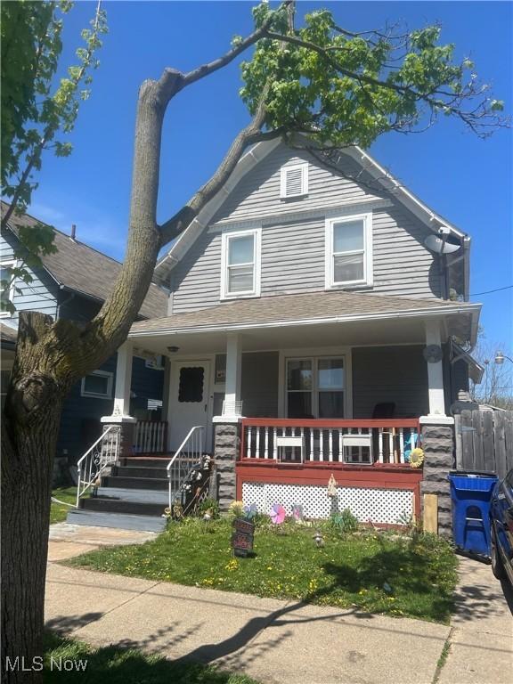 view of front facade featuring a porch and fence