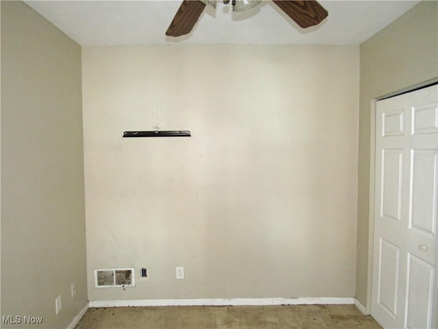 carpeted spare room featuring baseboards, ceiling fan, and visible vents