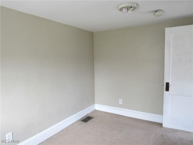 empty room with visible vents, carpet flooring, and baseboards
