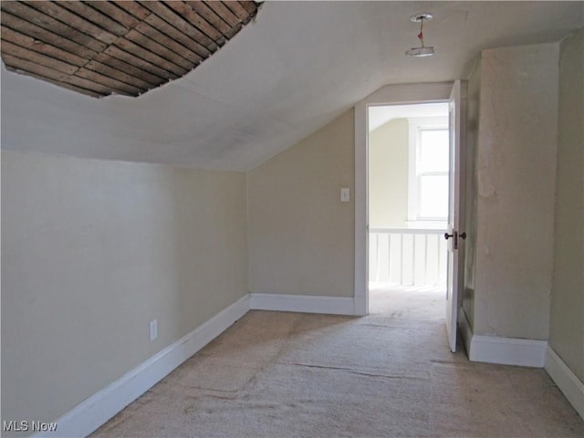 bonus room featuring carpet floors, baseboards, and vaulted ceiling