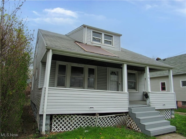 bungalow-style house with a porch and a shingled roof