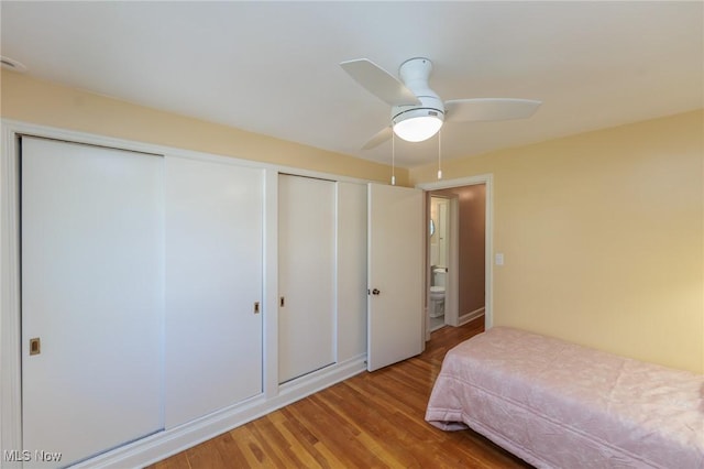 bedroom with a closet, a ceiling fan, and light wood finished floors
