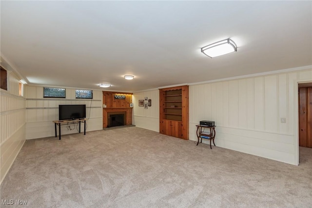 finished below grade area featuring carpet and a fireplace