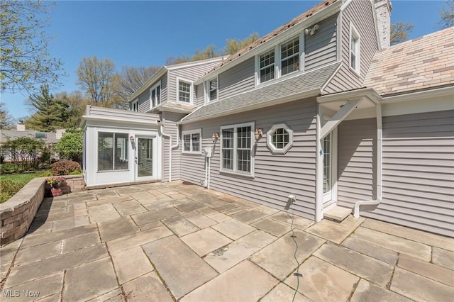 back of property featuring a patio area