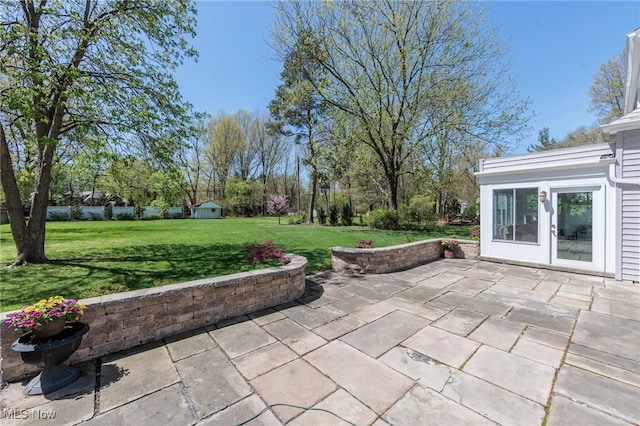 view of patio featuring an outbuilding and a shed